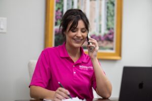 A Mosquito Authority franchise owner on the phone in their office.